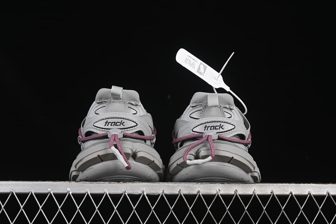 Pair of sneakers viewed from the heel, showing Track branding