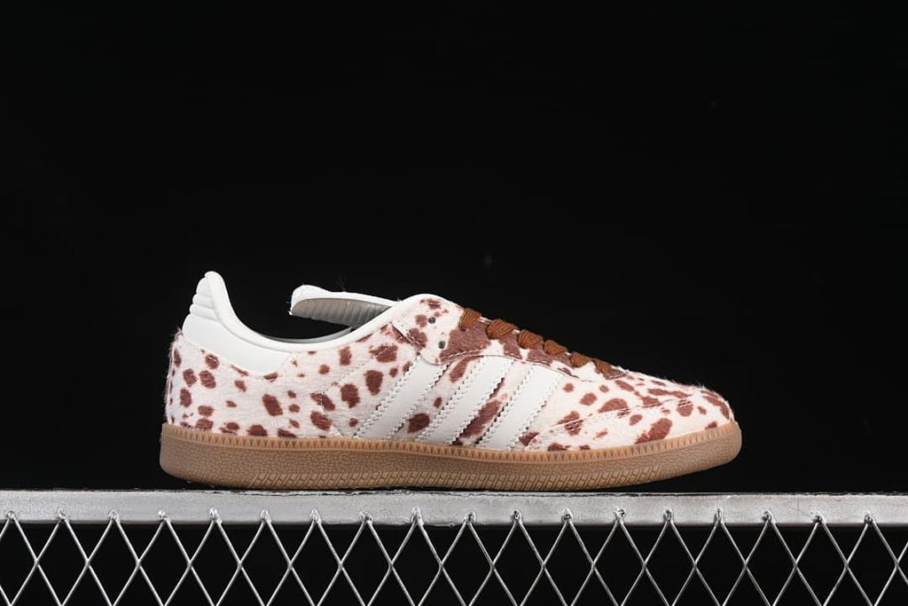 Side profile of a spotted low-top sneaker with white stripes and gum sole