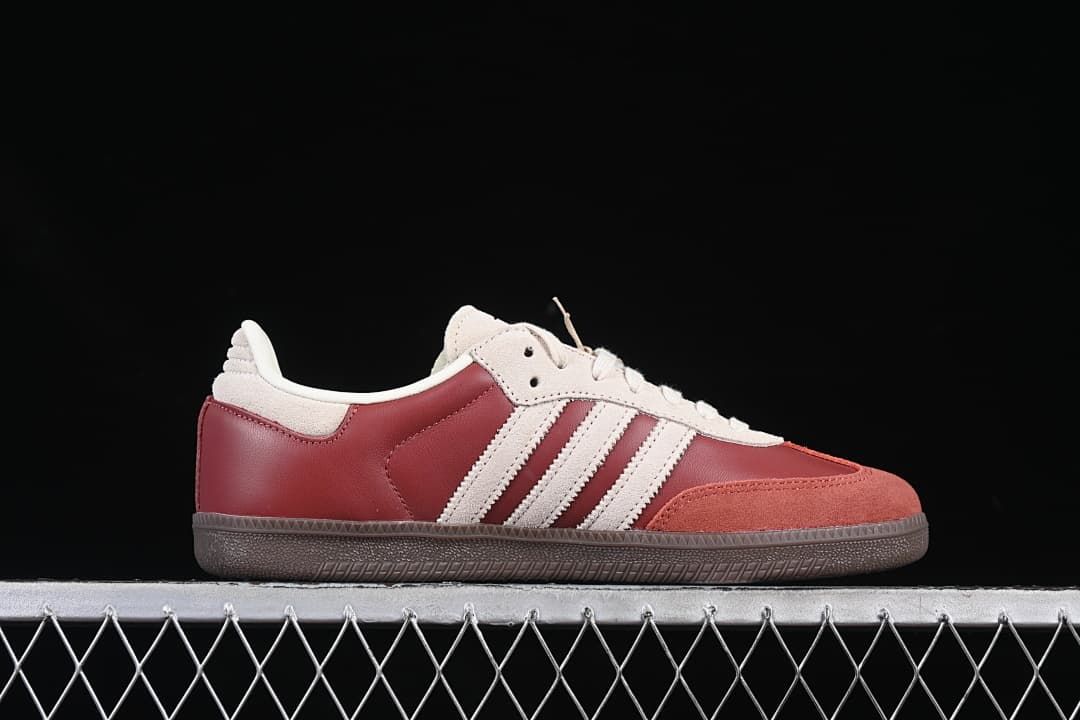 Side view of the burgundy and cream low-top sneaker