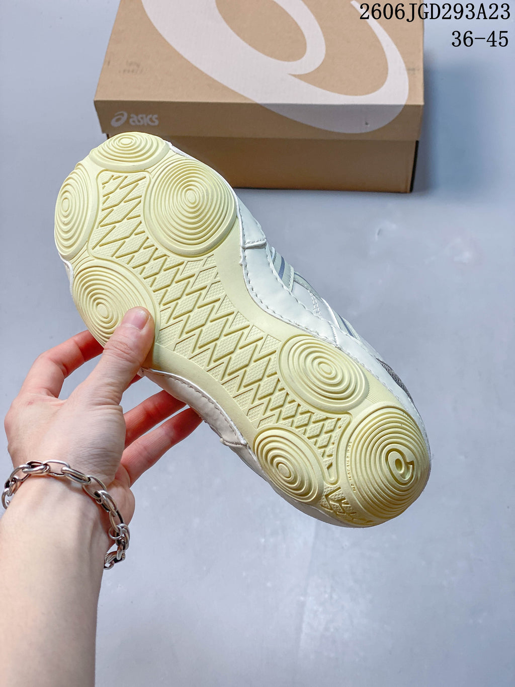 Close-up of the cream sneaker outsole with circular tread details