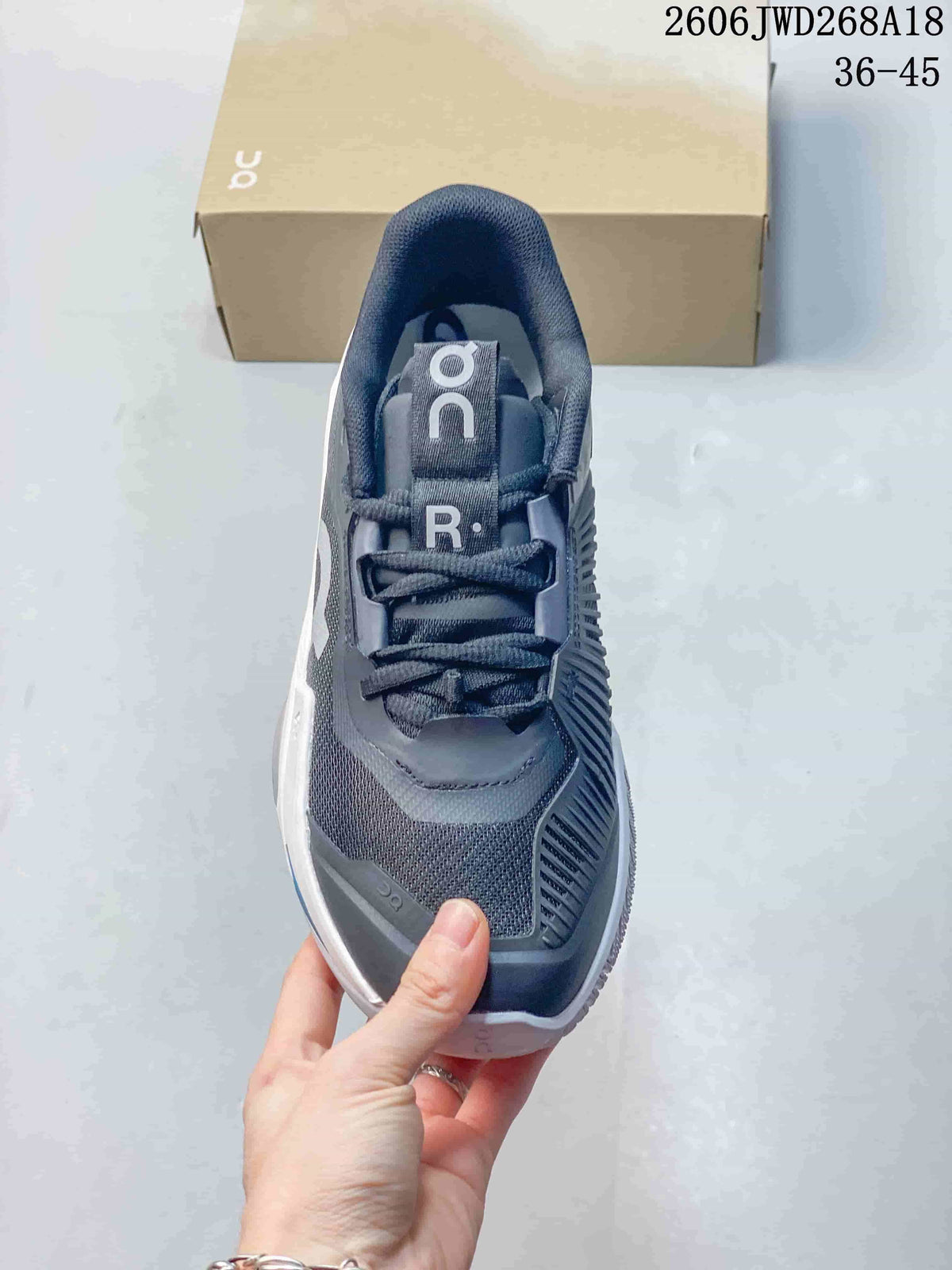 Top view showing the laces, tongue, and gray upper of the tennis shoe.