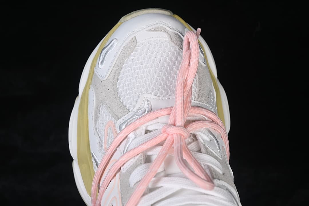 Top view of the sneaker toe, mesh panel, and pink laces.