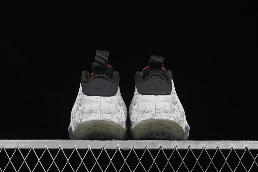 Rear view of both shoes with translucent outsoles.