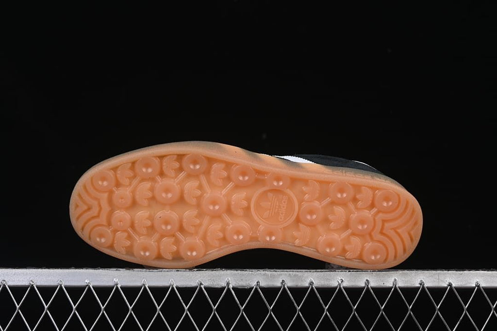 Underside of a translucent gum-colored outsole with circular tread details.