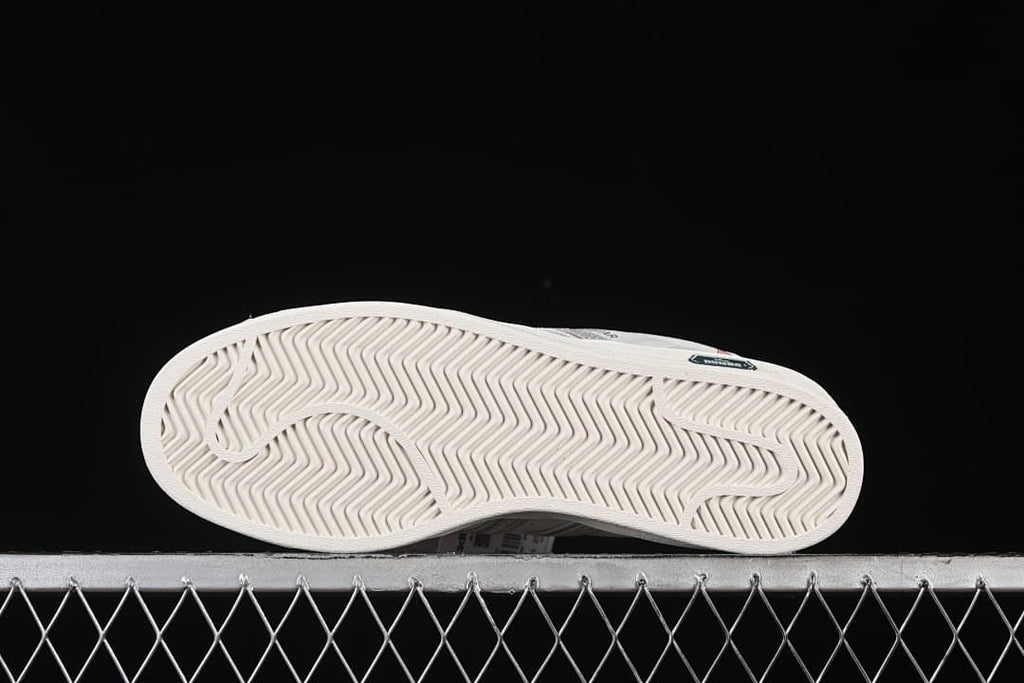 Underside view showing the sneakers' patterned outsoles