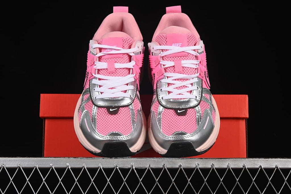 Front view of the pair showing pink uppers, silver-look overlays, and white laces