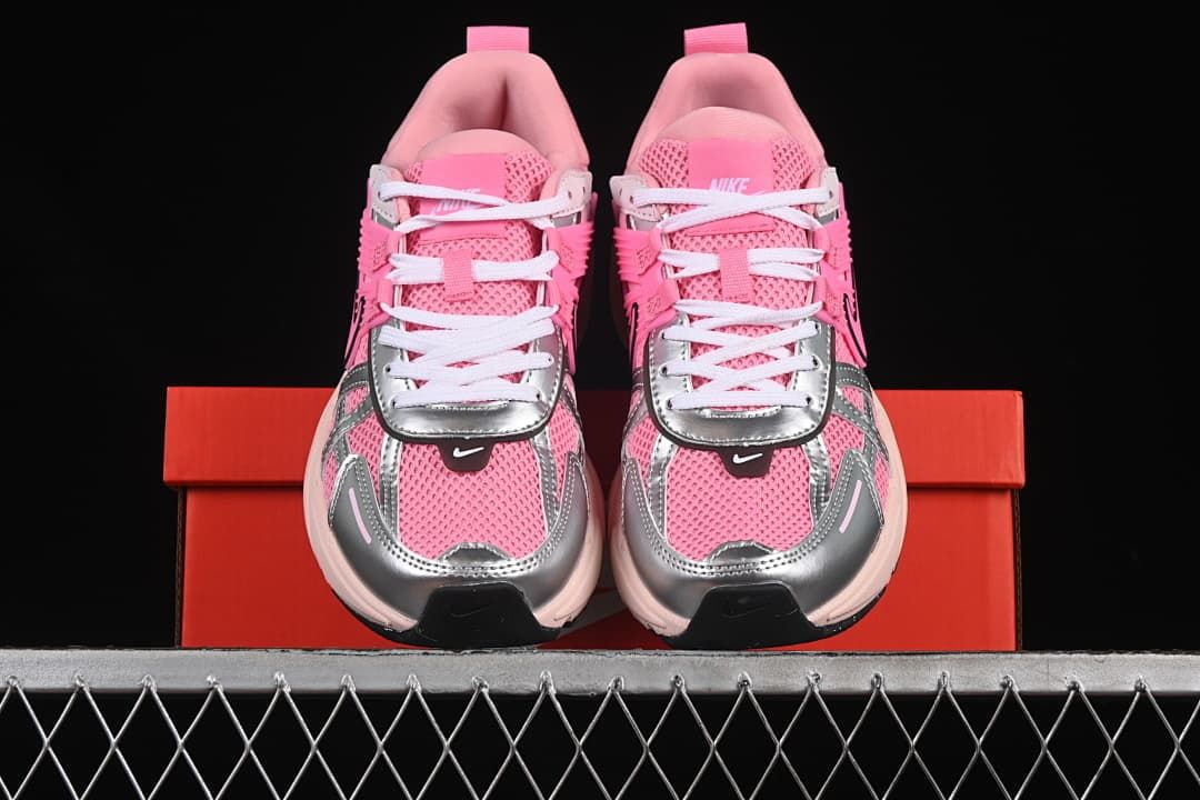 Front view of the pair showing pink uppers, silver-look overlays, and white laces