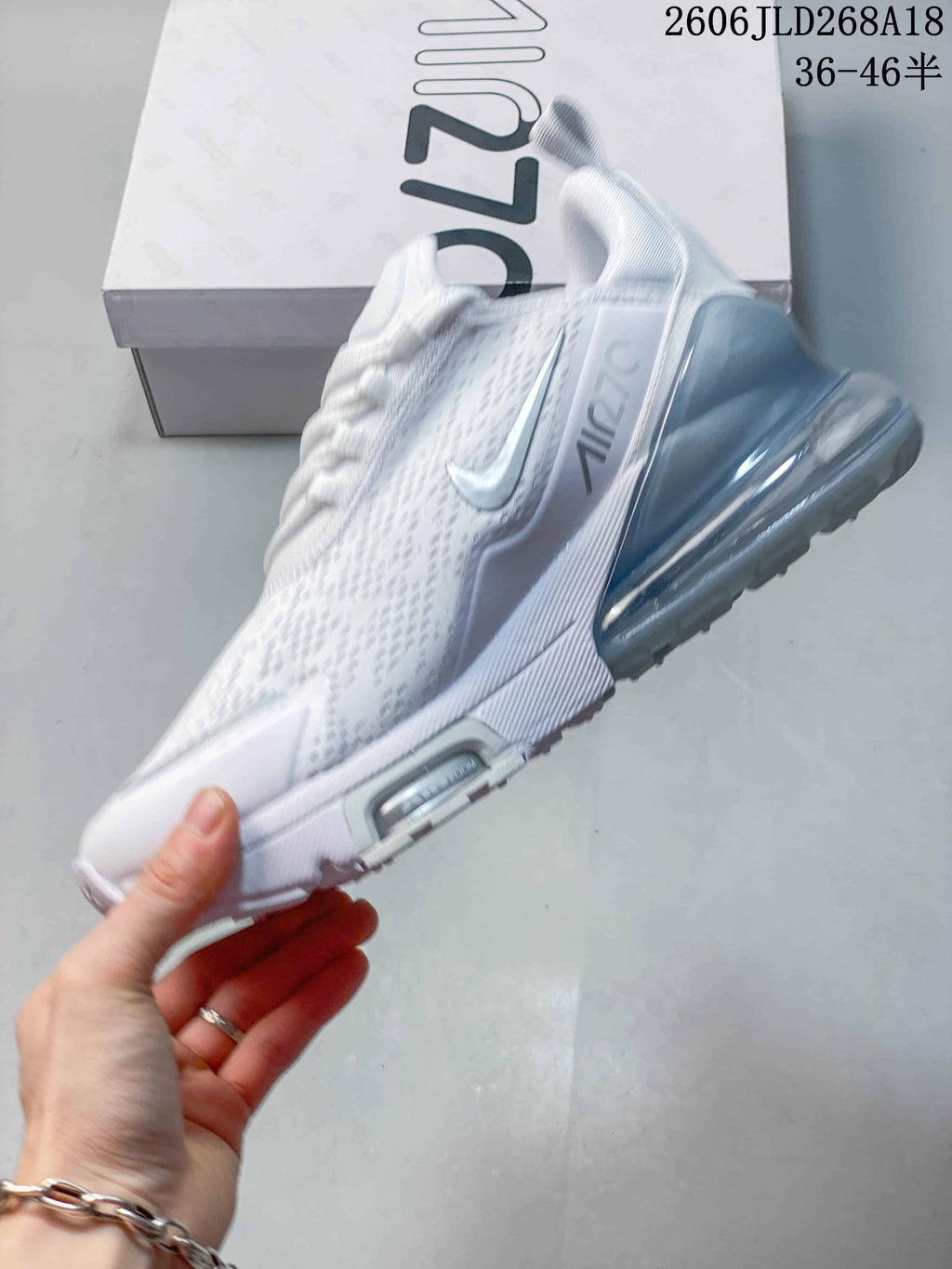 Side profile of a white Nike Air Max Pulse shoe with a translucent heel unit