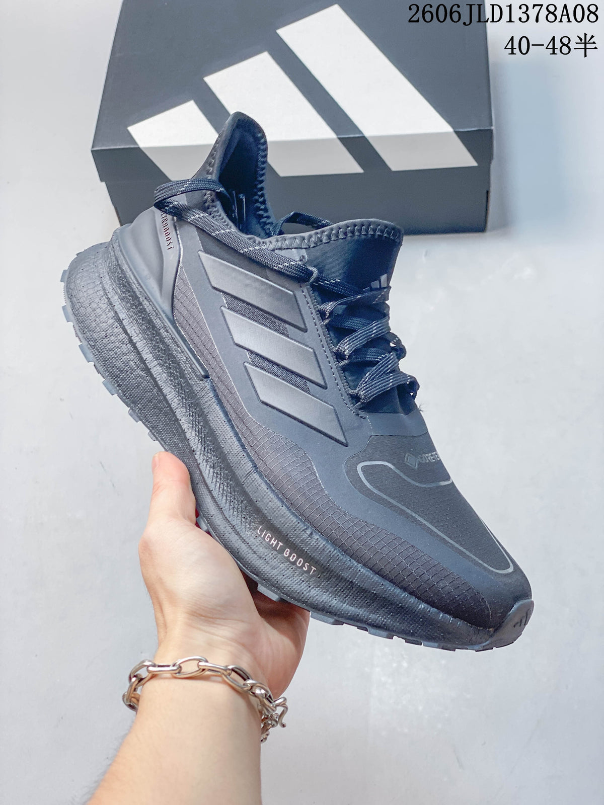 Angled side view highlighting the three-stripe detailing and sole