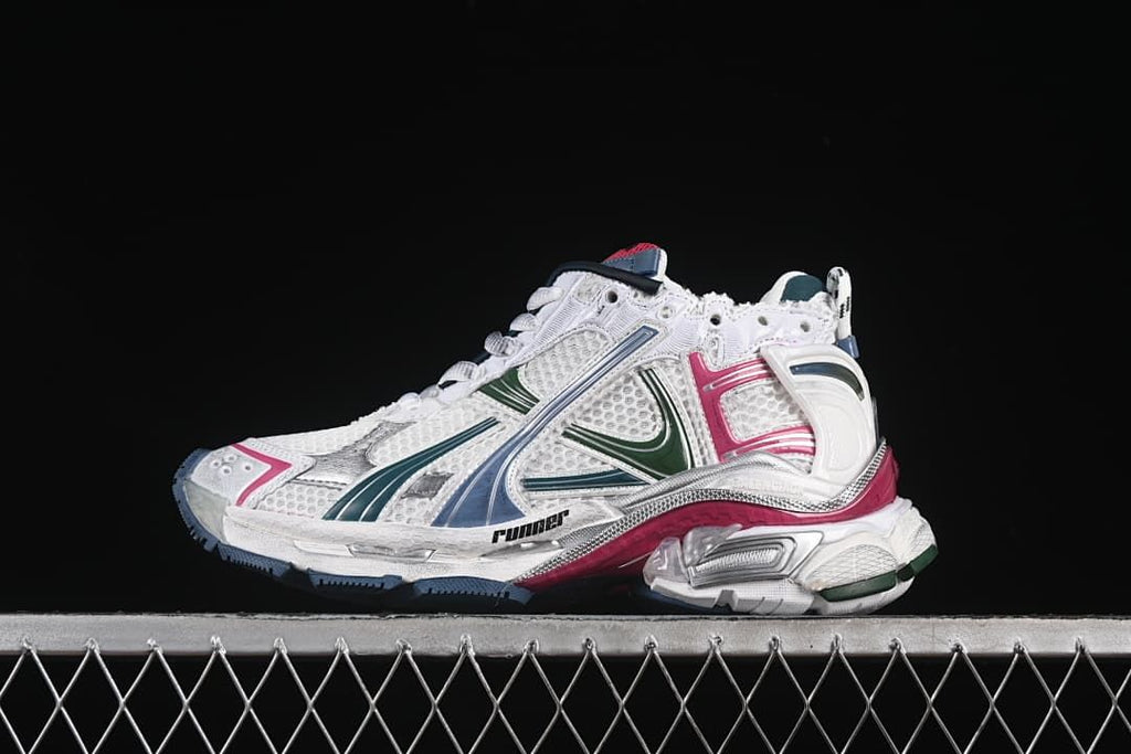 Side view of a white Balenciaga Runner sneaker with green, blue, silver, and pink accents