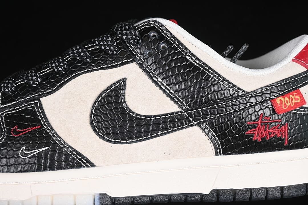 Close-up of the black scale-pattern overlays, swoosh, and red side details