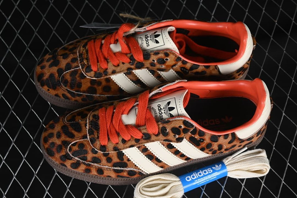 Pair of leopard-print Samba OG W sneakers with an additional cream-colored lace set