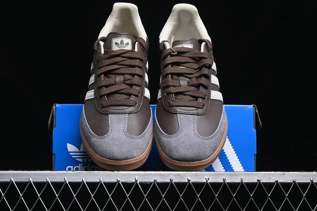 Front view of the pair showing grey toe panels, brown laces and gum soles