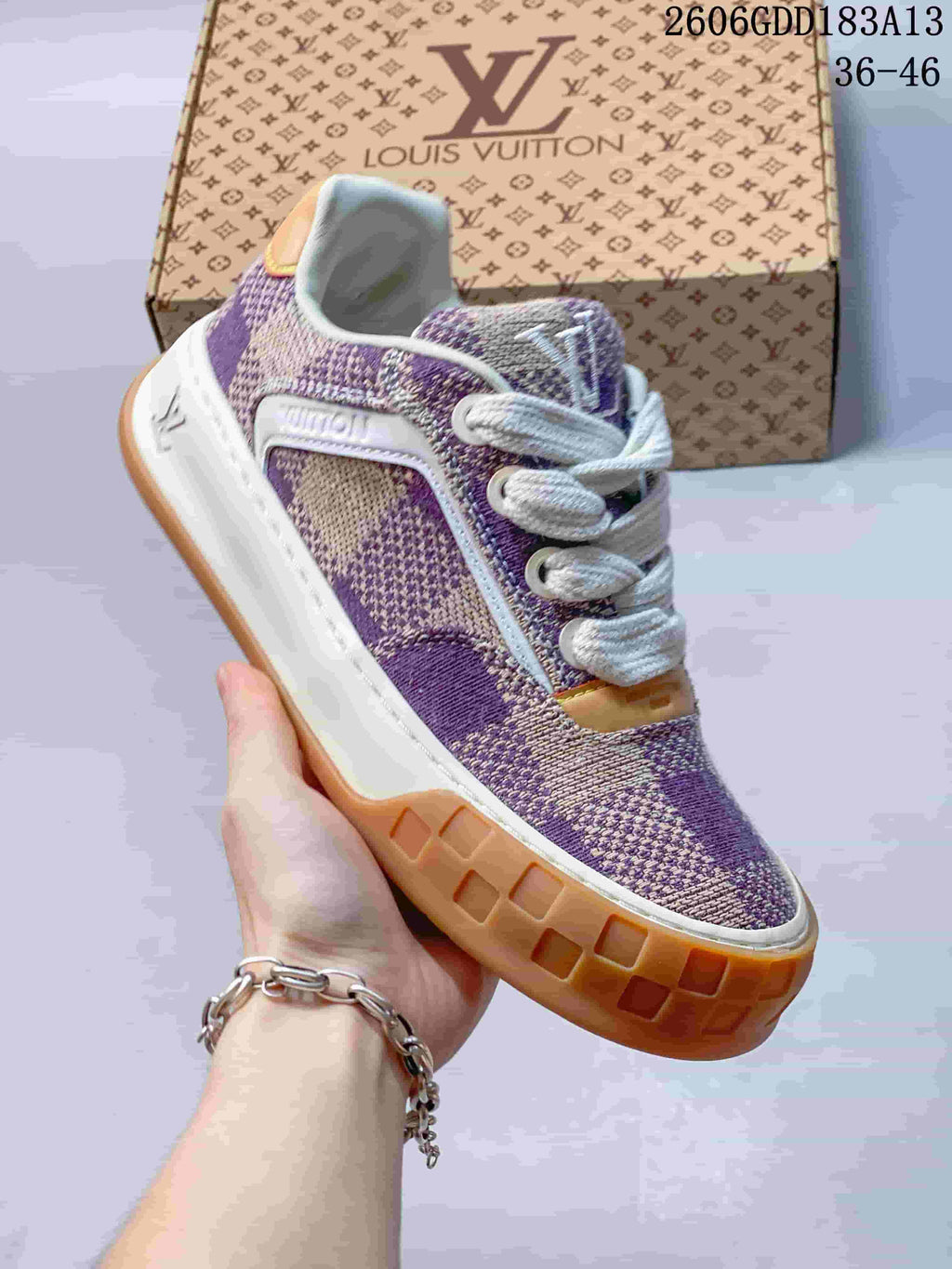 Angled side view of the purple and beige check-patterned sneaker with chunky two-tone sole