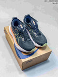 Pair of dark charcoal ASICS running shoes with lime accents and white midsoles, displayed on a shoe box.