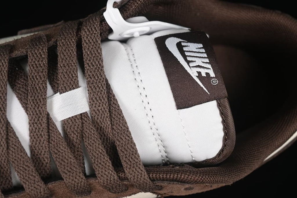 Close-up of brown laces and the tongue label