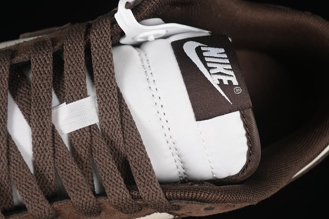 Close-up of brown laces and the tongue label