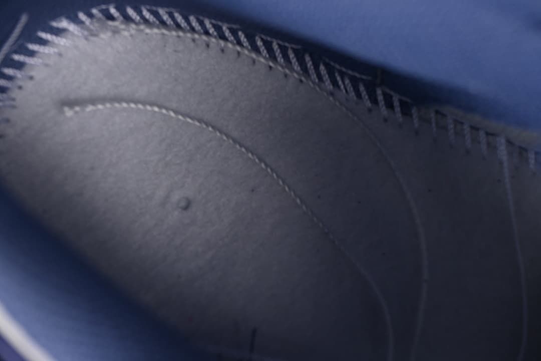 Close-up of stitching and panel details inside the blue sneaker