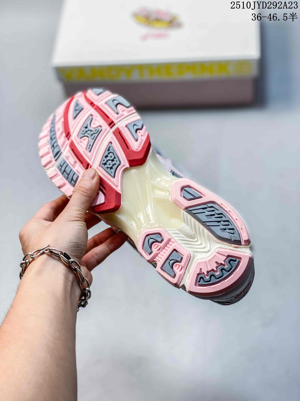 Close-up of the sneaker outsole with pink and gray tread sections