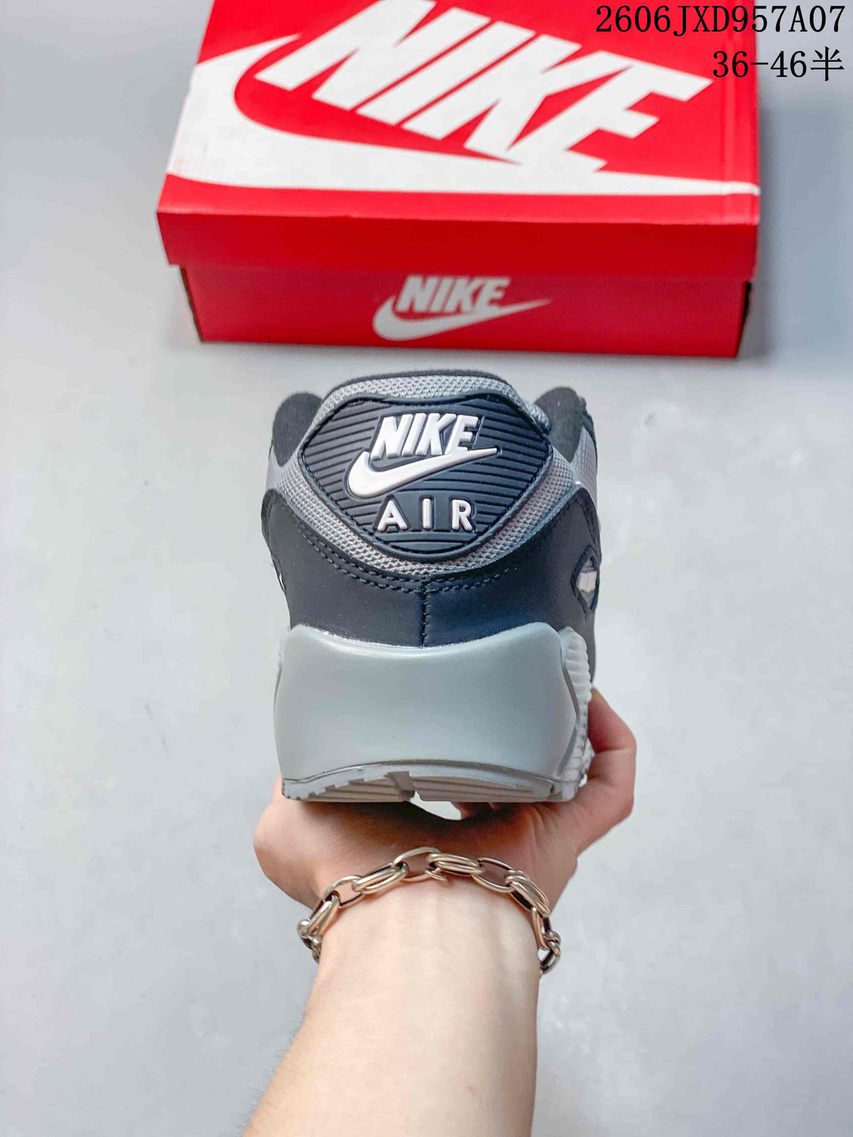 Rear view of a Nike Air Max 90 sneaker showing the heel branding and gray midsole.
