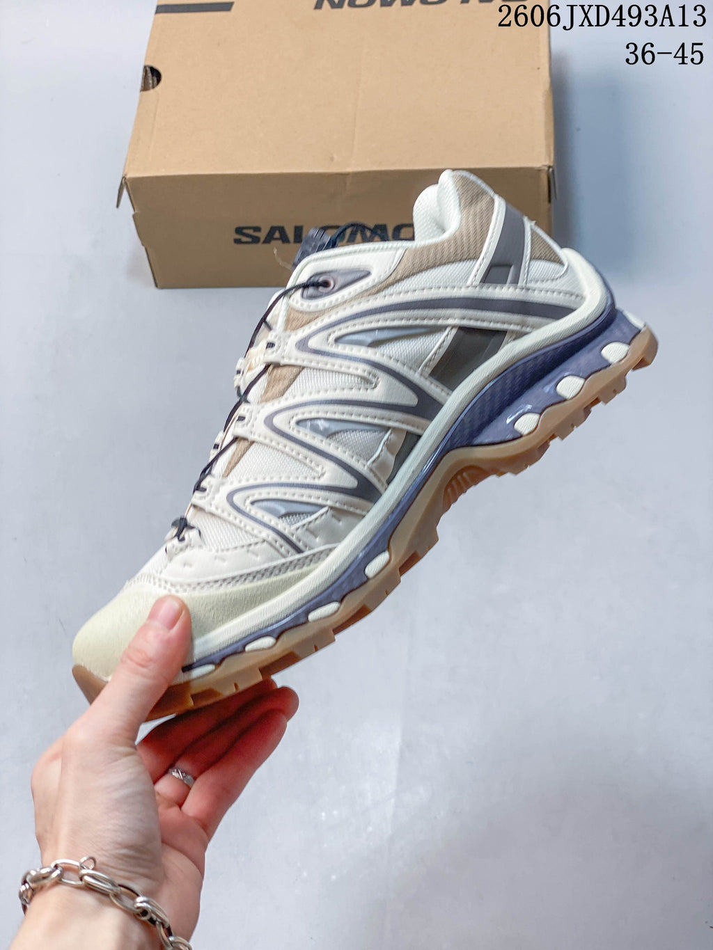 Side view of a cream and sand-gray Salomon XA Pro 3D sneaker.