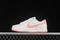 Side view of off-white and pink Nike SB Dunk Low sneakers