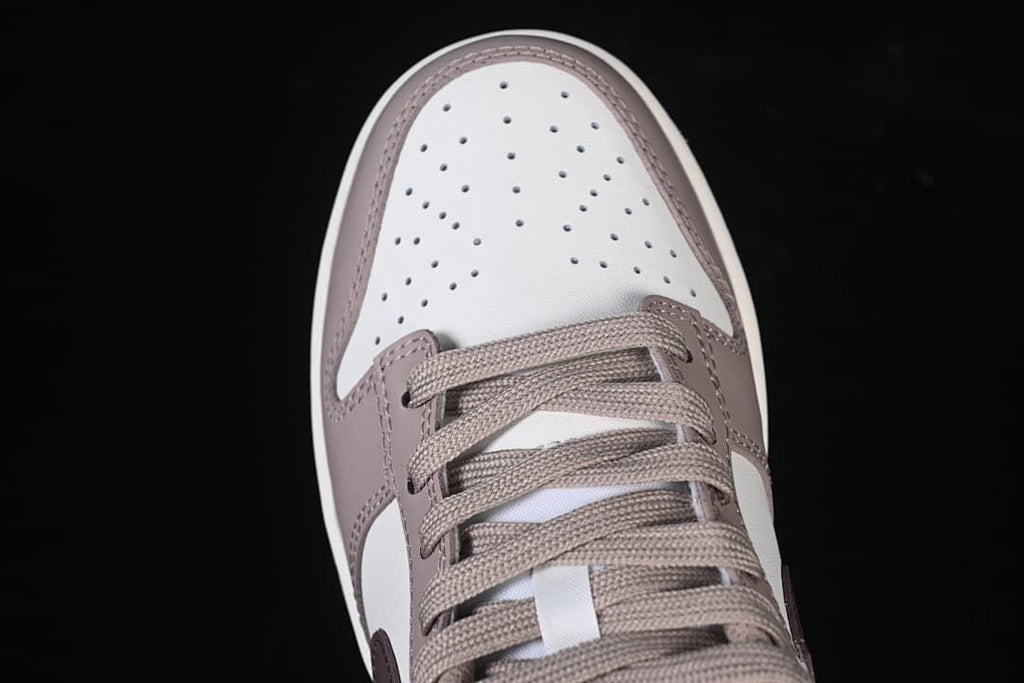 Top-down close-up of the perforated toe box and laces.