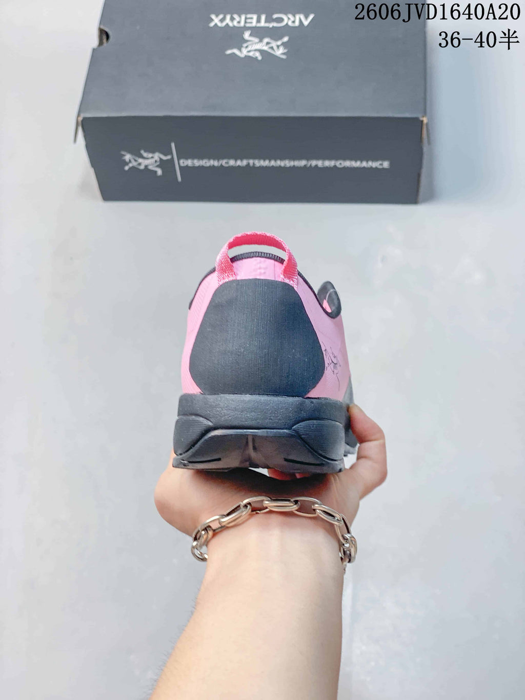 Rear view showing the shoe heel, pull tab, and dark sole