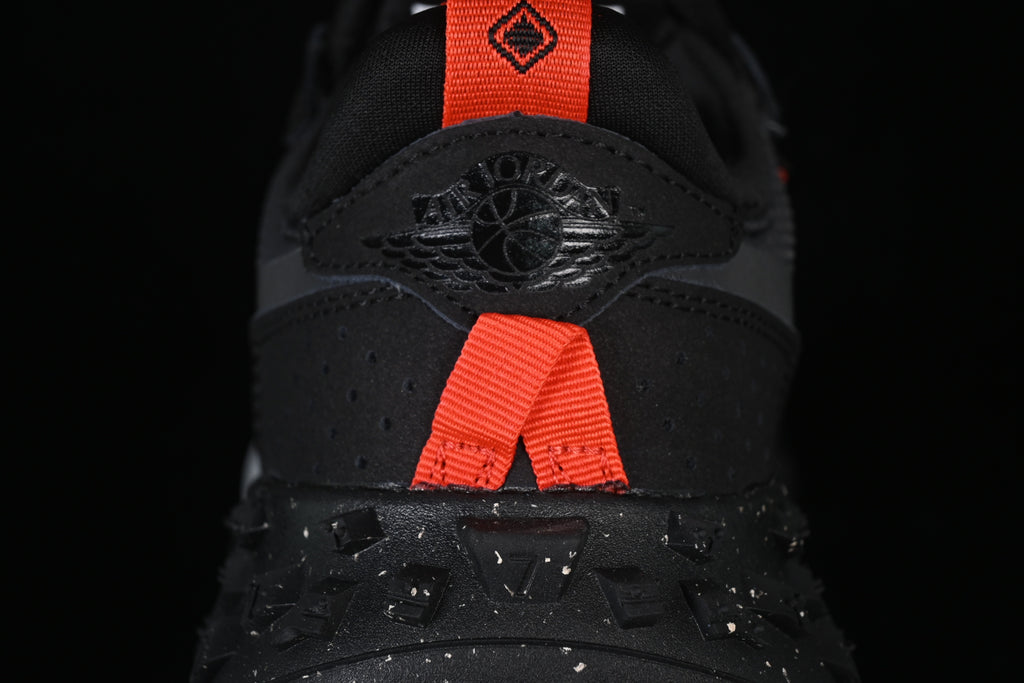 Close-up of the heel with an Air Jordan logo and bright orange pull tabs