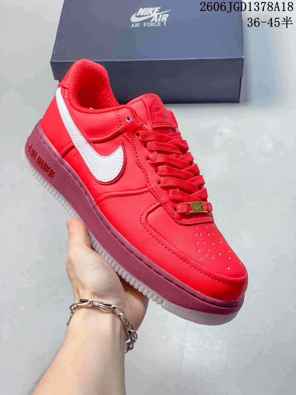 Angled side view of a red low-top sneaker with a white Swoosh and contrasting sole