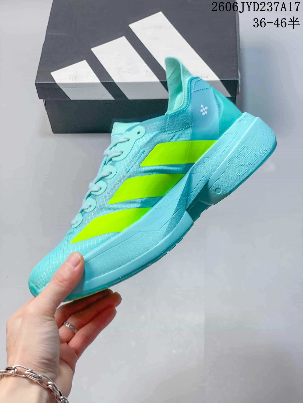 Side view of an aqua running shoe with three neon yellow stripes