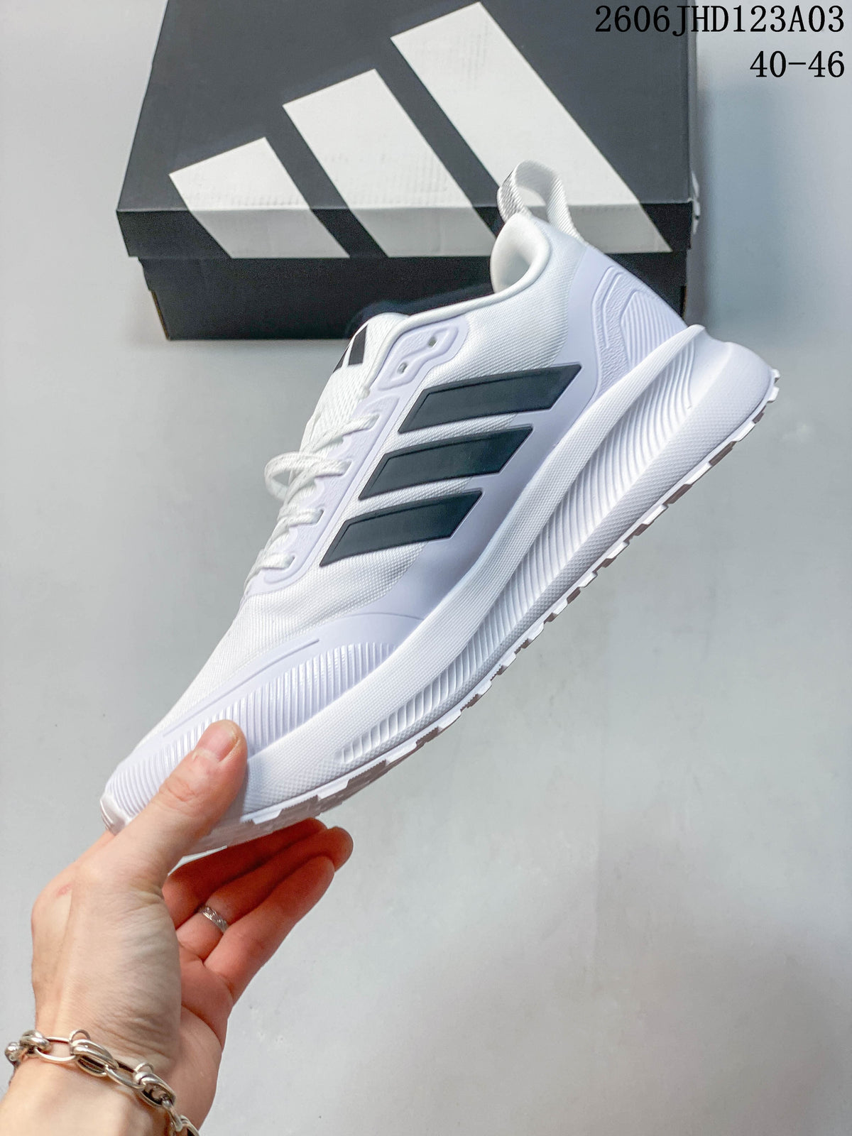 Side view of a white Adidas Runfalcon 5 TR sneaker with black stripes