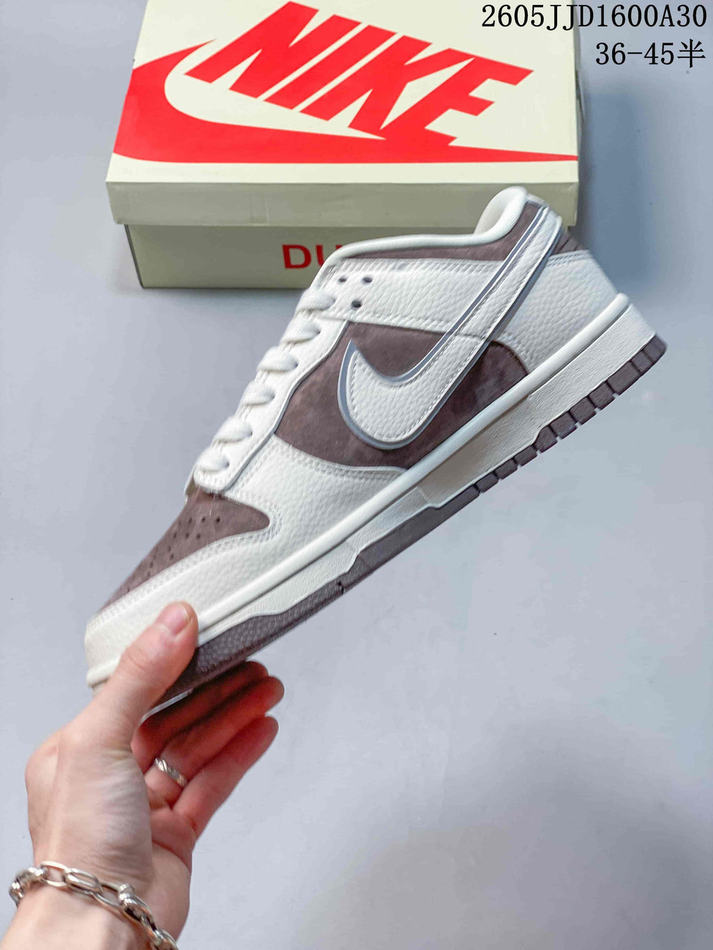 Side view highlighting the off-white upper and mauve-brown Swoosh panels