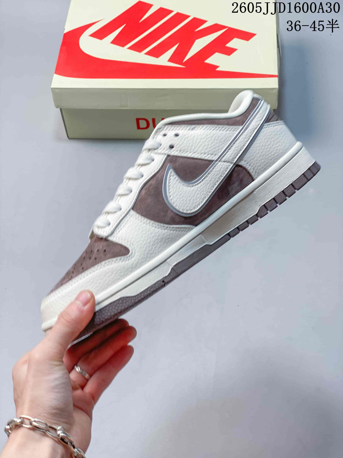 Side view highlighting the off-white upper and mauve-brown Swoosh panels