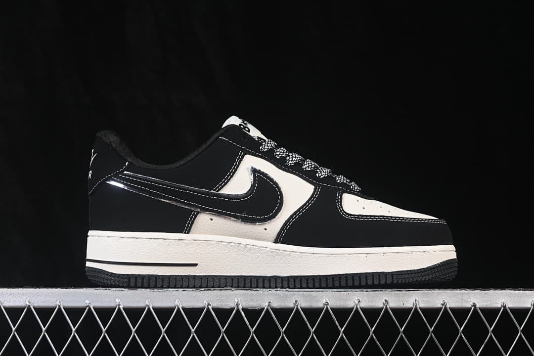 Side profile of black and off-white low-top sneakers with patterned laces and contrast stitching.