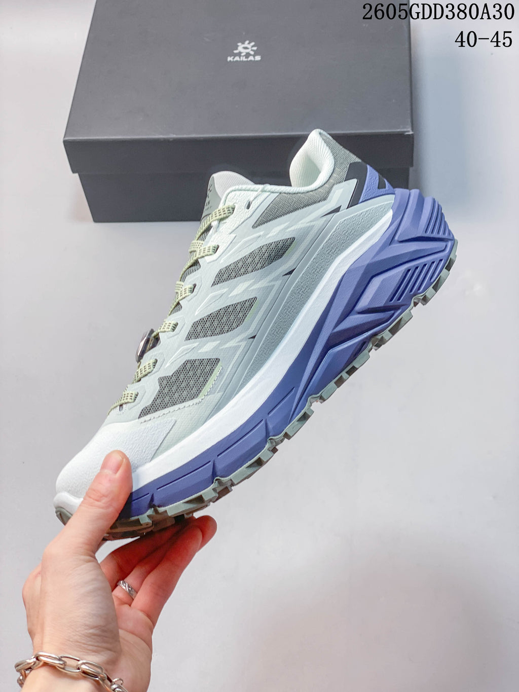 Side view of a light blue, gray, white, and violet Kailas C4 trail shoe.
