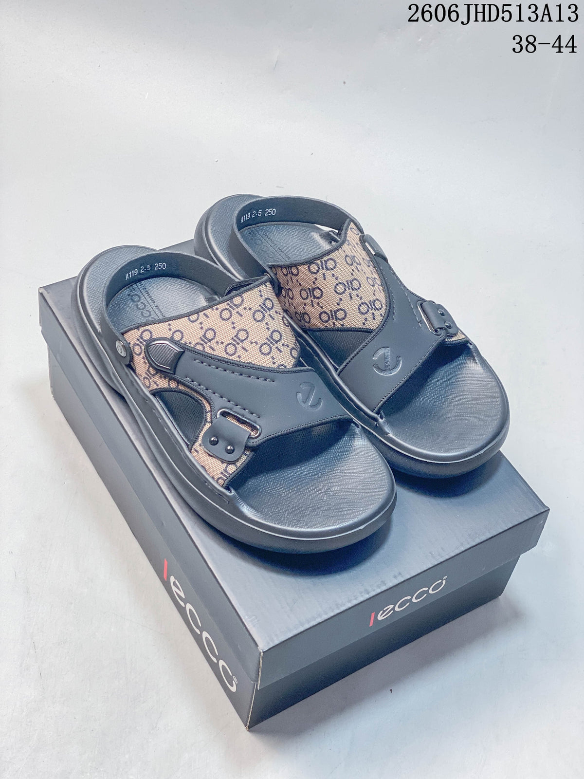 Pair of gray open-toe slide sandals with patterned panels and a box; image overlay shows sizes 38–44 and style code 2606JHD513A13.