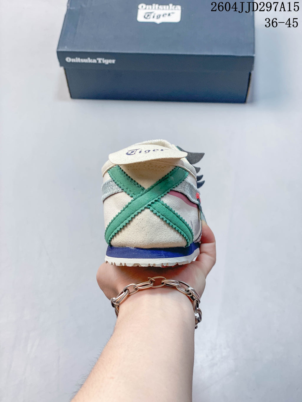 Rear view of the sneaker showing crossed green heel overlays