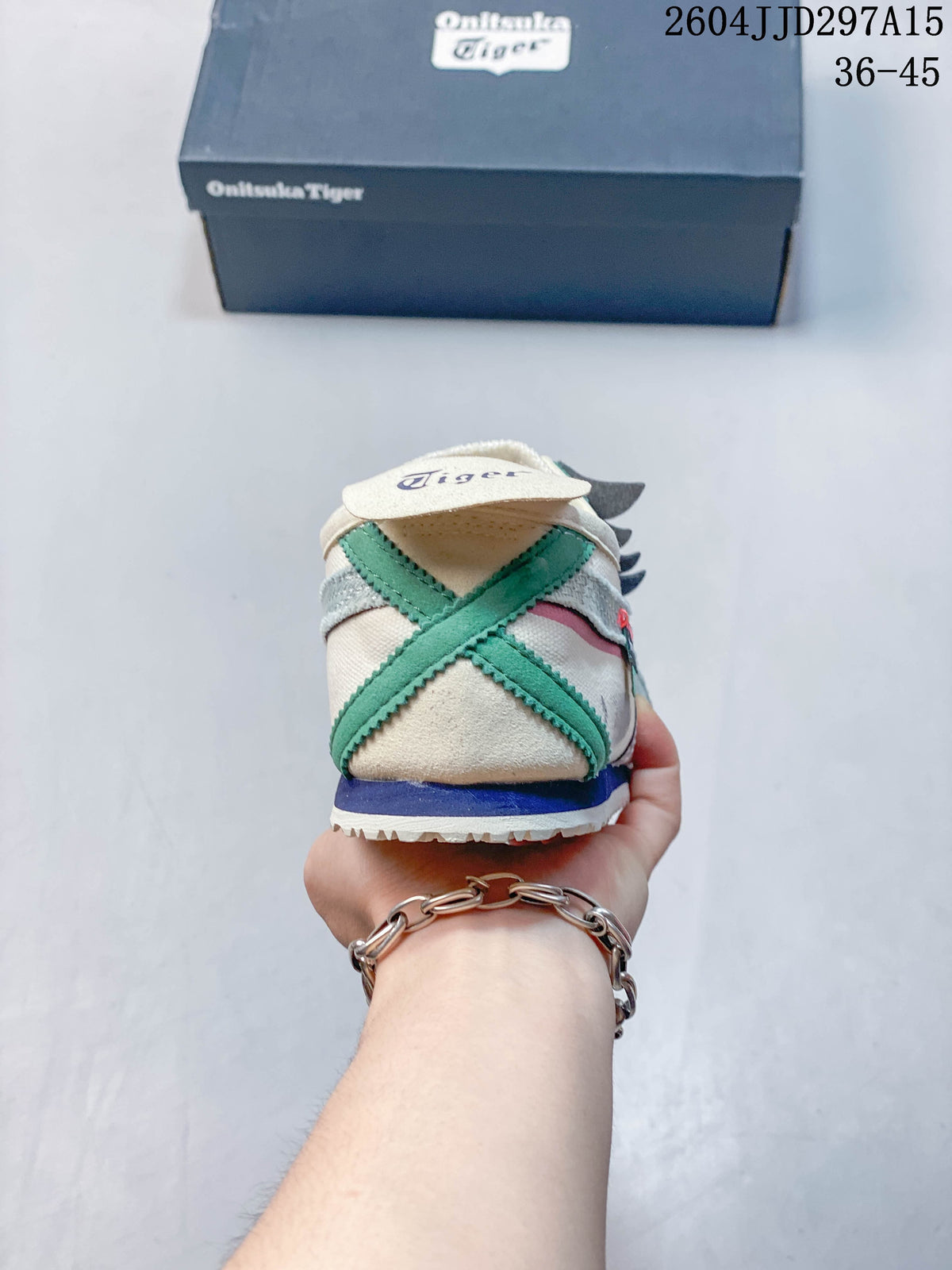Rear view of the sneaker showing crossed green heel overlays