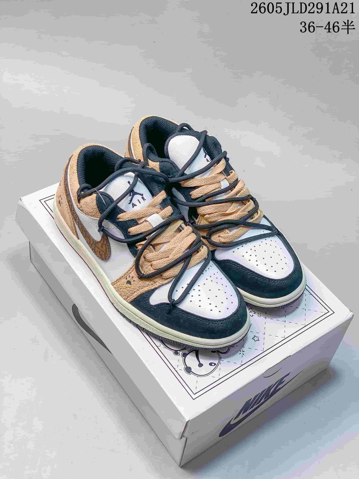Pair of tan, white, and dark navy low-top sneakers displayed on a Panda Land box