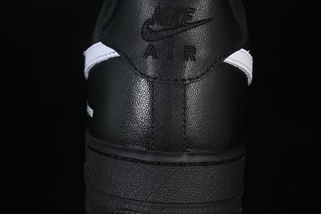 Rear view of the black shoe with Nike Air branding on the heel tab
