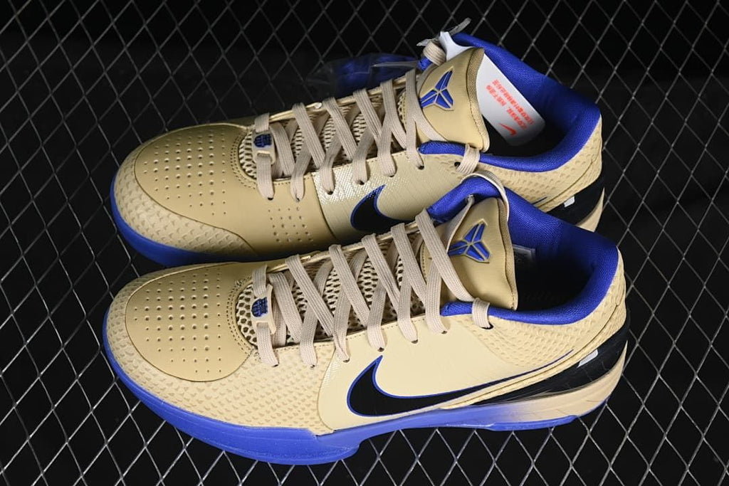 Pair of cream and blue shoes shown from above at an angle.