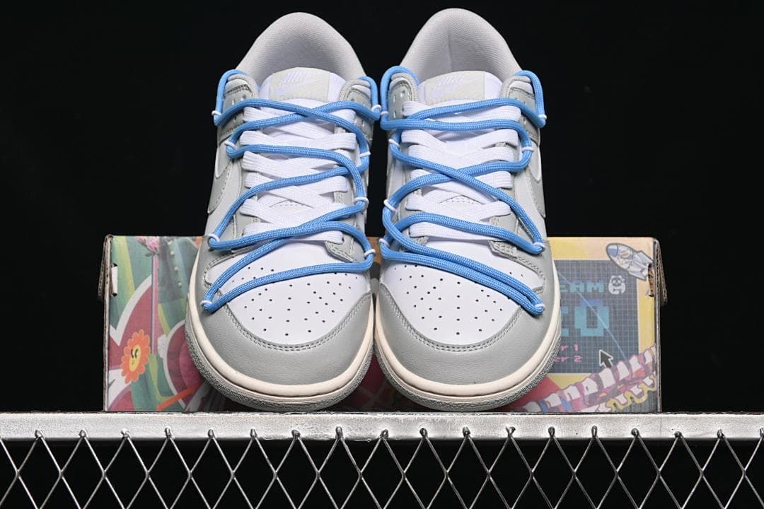 Front view of the pair showing perforated toes and blue laces