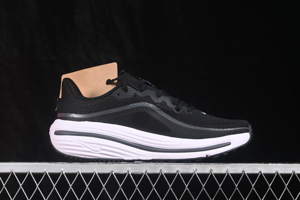 Side view of a single black Nike running sneaker with a white midsole and dark outsole.