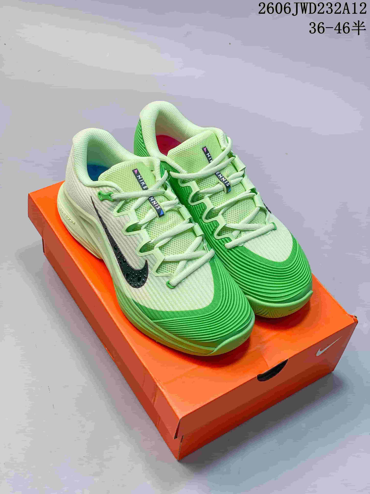 Pair of green and pale cream Nike Zoom Vapor 12 HC PRM tennis shoes on an orange shoebox