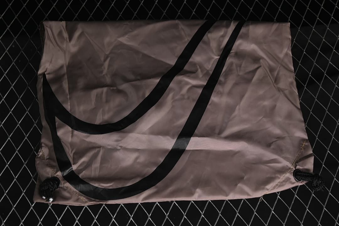 Drawstring shoe bag displayed against a dark background