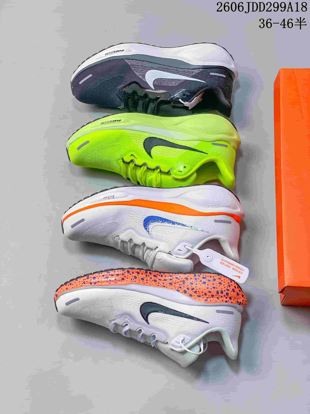 Four Nike running shoes displayed in white-orange, neon yellow, and dark gray colorways