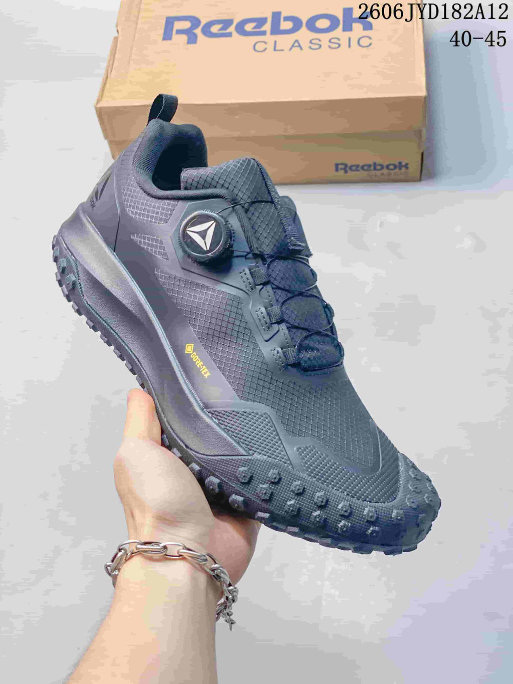 Side view of a charcoal Reebok sneaker with a visible GORE-TEX mark.