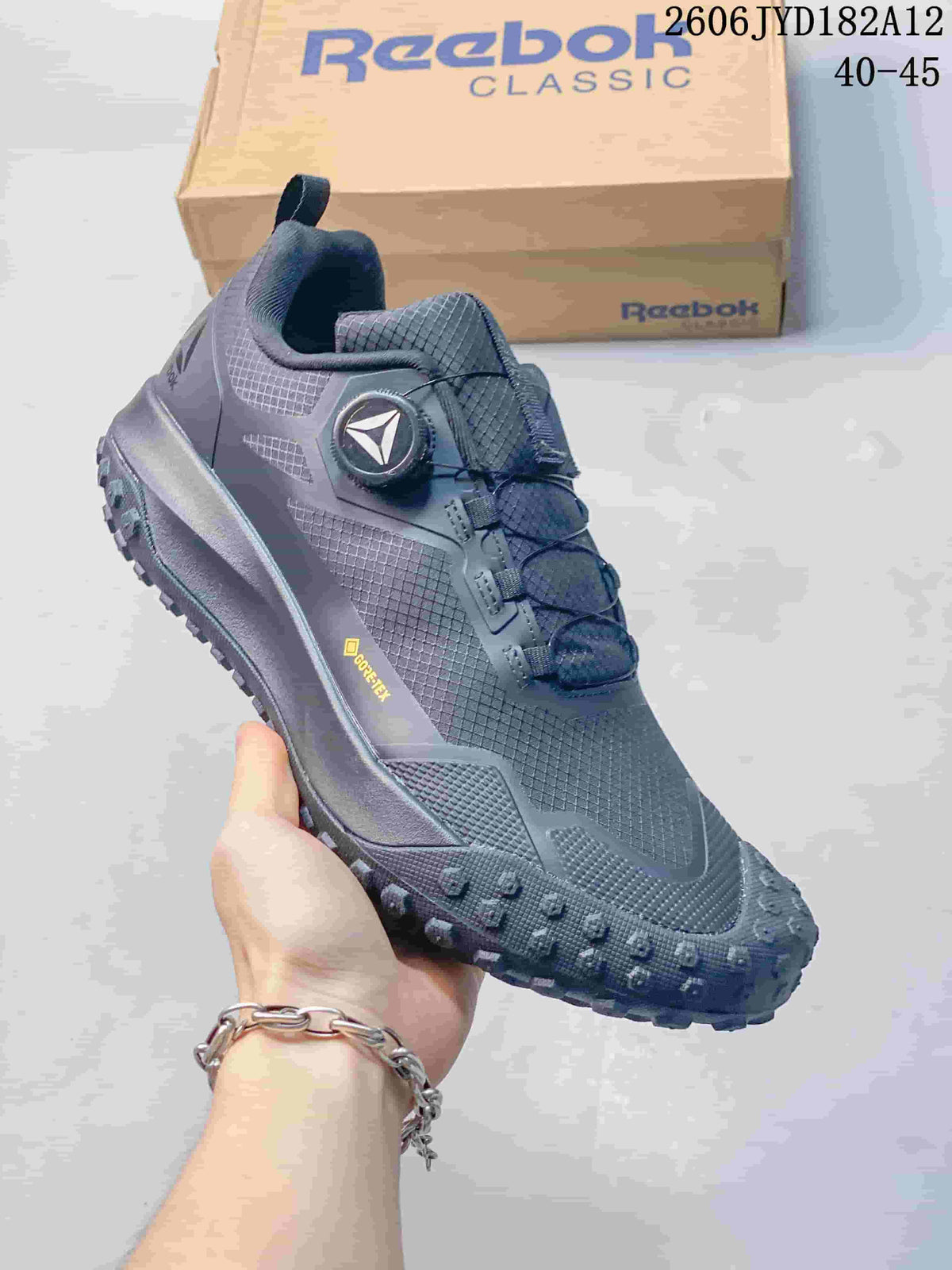 Side view of a charcoal Reebok sneaker with a visible GORE-TEX mark.