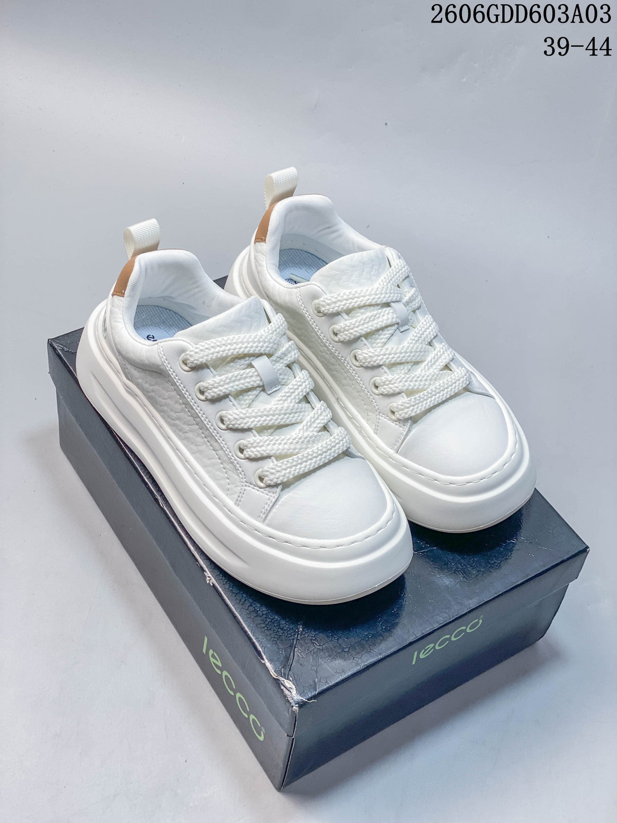 Pair of white Ecco Biom Fjuel low-top lace-up sneakers shown on a shoebox; image overlay states sizes 39–44.